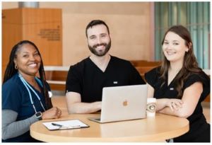 three people smiling at a table